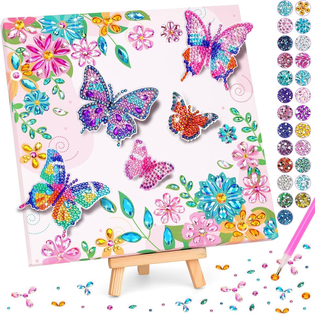 The finished butterfly canvas on its wooden easel, showing five raised gem butterflies among printed flowers, beside the tray of gem colours and the pink gem pen